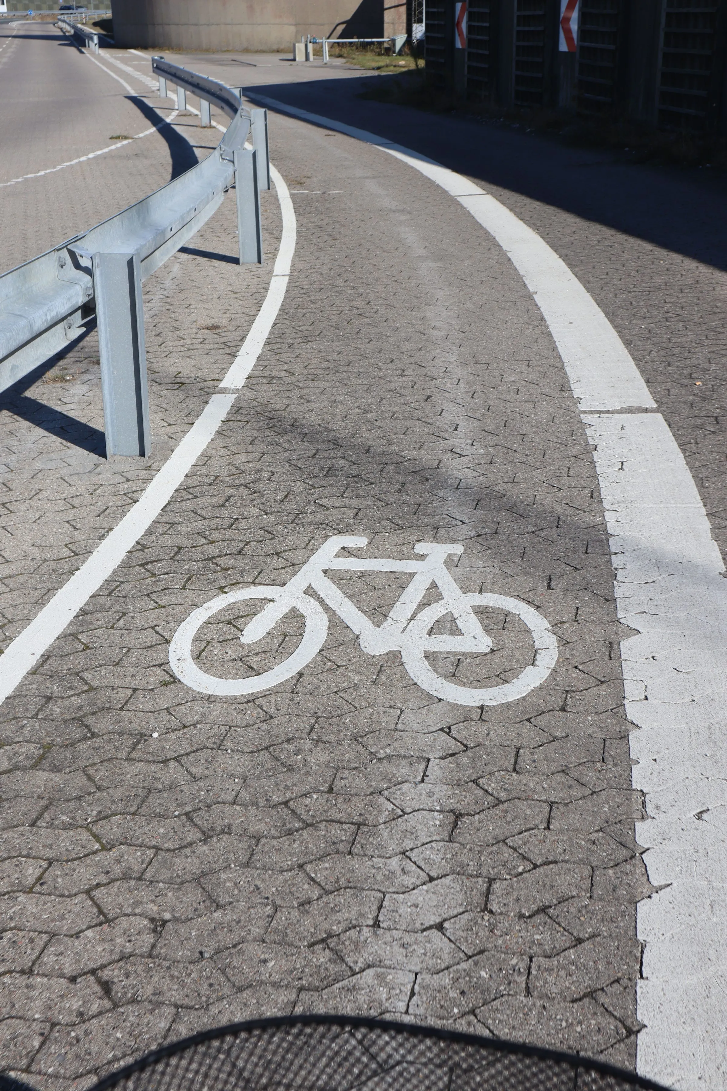 A bicycle symbol painted on the cycle lane running alongside the road into the ferry port