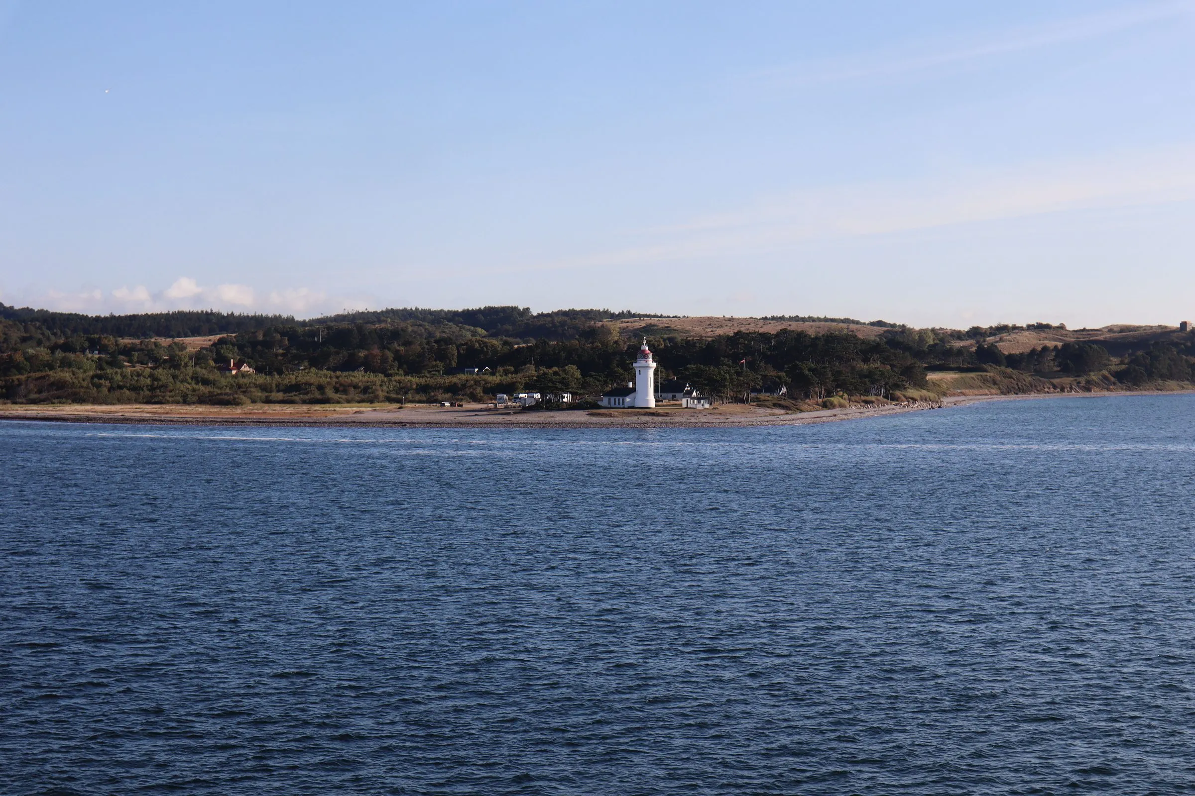 A lighthouse on the Danish coast seen from the deck of the ferry