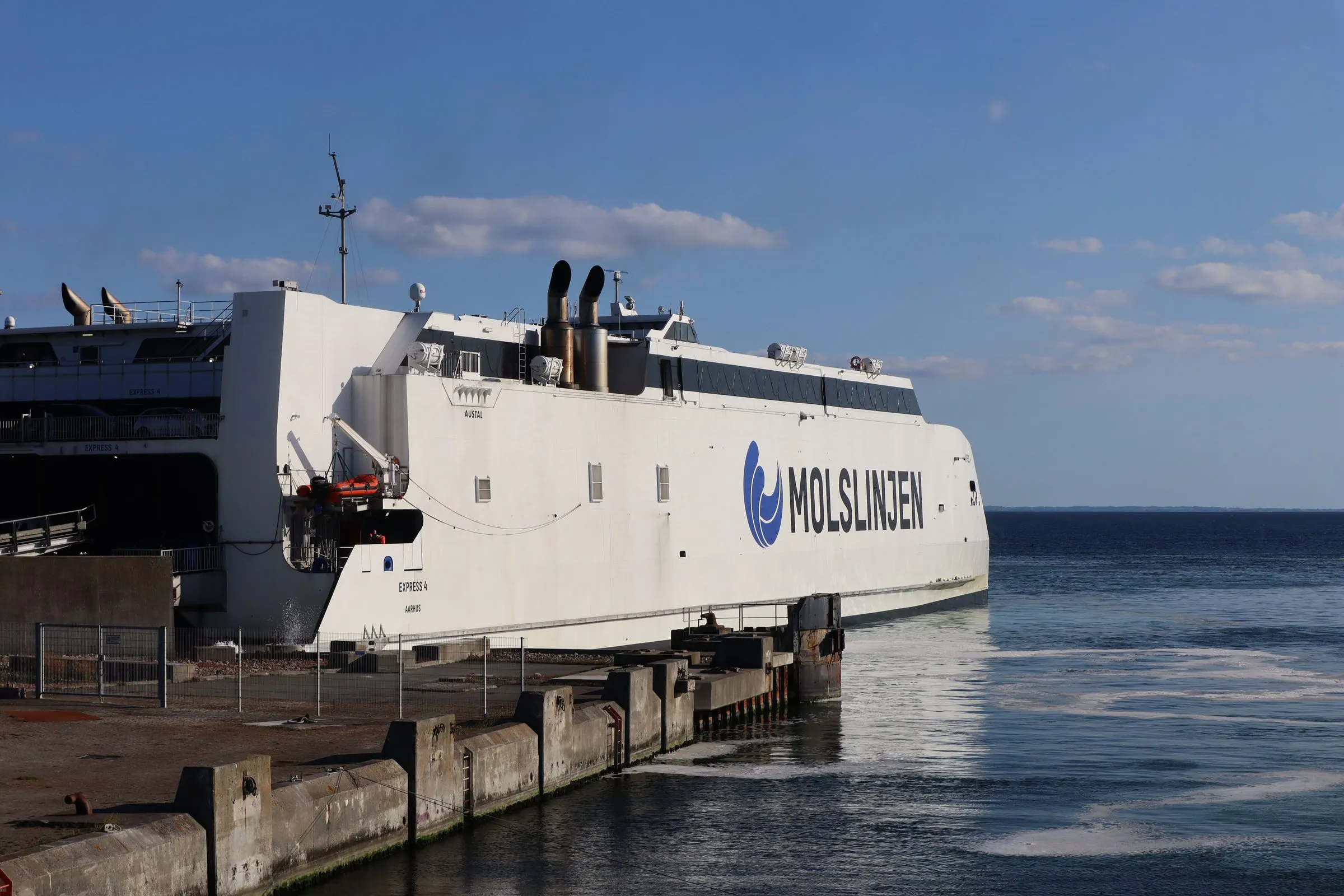 The open bow ramp of a Molslinjen Express catamaran at the quay